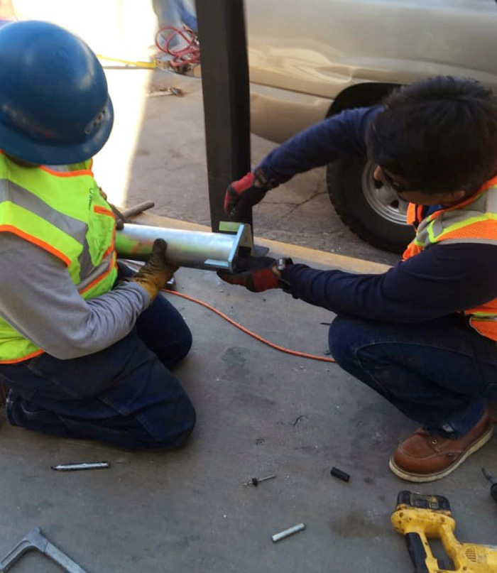 Workers Assembling Underground Utility Components